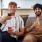 two men sitting on a couch