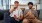 two men sitting on a couch