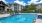 a swimming pool with chairs around it