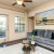 a living room with a couch and a fan