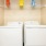 a white washing machine and a shelf